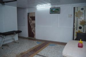 a room with a white wall and a door and a table at Dr Vijeta's Wellness Retreat in Alībāg +19 photos