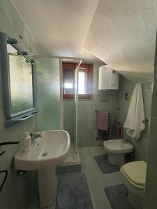 a bathroom with a sink and a toilet at B&B Resort Tina in Gesualdo +29 photos