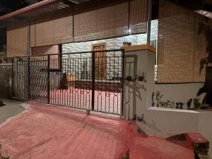 an entrance to a building with an open gate at SM Cottage in Mangalore