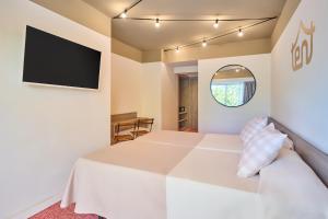 a bedroom with a bed and a flat screen tv at tent Playa de Palma in Playa de Palma