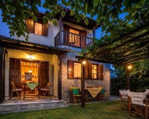 a house with a table and chairs in the yard at Deja Blue in Mouresi
