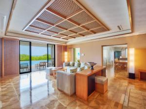 a living room with a couch and a table at Miyakojima Kurima Resort Seawood Hotel in Miyako-jima