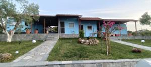 a blue house with chickens in the yard at blue caravan in Nea Potidaea +9 photos