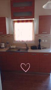 a kitchen with a heart painted on the counter at blue caravan in Nea Potidaea