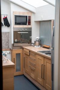 a kitchen with a sink and a microwave at Maison AMARE 200 m de la plage in Berck-sur-Mer +5 photos