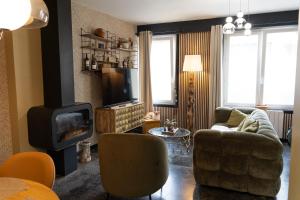 a living room with a couch and a fireplace at Maison AMARE 200 m de la plage in Berck-sur-Mer