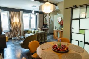a living room with a table and a couch at Maison AMARE 200 m de la plage in Berck-sur-Mer