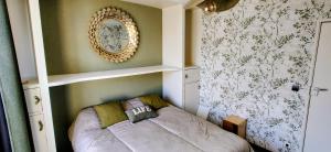 a bedroom with a bed with a mirror on the wall at Maison AMARE 200 m de la plage in Berck-sur-Mer
