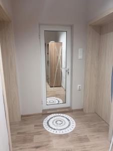 a bathroom with a mirror on the floor at Апартамент Кари in Yambol +19 photos