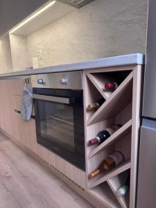 a kitchen with a counter with wine bottles at Апартамент Кари in Yambol