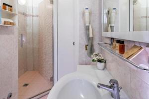 a white bathroom with a shower and a sink at Hotel Tre Rose New 2026 in Riccione +15 photos