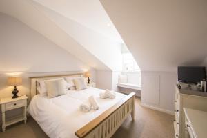 a bedroom with a white bed with towels on it at The Fox Inn in Ansty