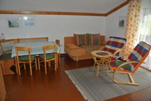 a living room with a table and chairs and a couch at Haus Pock Apartments in Lake Pressegg
