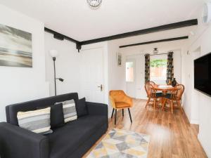 a living room with a couch and a table at Oar Cottage in Mablethorpe