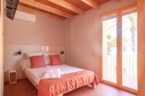 a bedroom with a bed and a large window at La Rogeta in Tabarca +12 photos