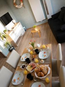 a table with plates of food on it in a living room at Ferienwohnung Seepferdchen in Schönberg