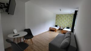 a living room with a couch and a table at Noclegi Na Gołębiówce in Wadowice
