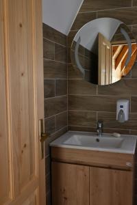 a bathroom with a sink and a mirror at Eco Lux Prokletije resort in Gusinje +56 photos