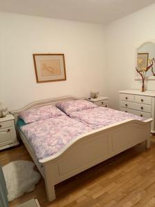 a bedroom with a bed and two dressers and a mirror at Ferienwohnung Altes Rüsthaus in Ilz