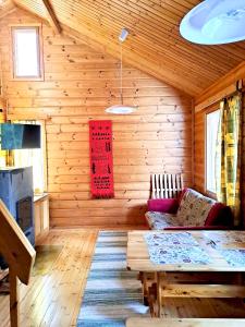 a living room with a couch and a table at Holiday Home Marina in Tahkovuori