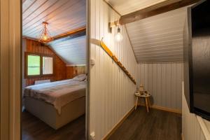 a bedroom in a tiny house with a bed at Grange des 2 Cols - Jacuzzi - Jardin in Campan