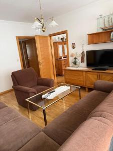 a living room with a couch and a coffee table at Ferienwohnung Altes Rüsthaus in Ilz