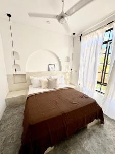 a bedroom with a large bed and a large window at Casa Mysa Villas in Michamvi +81 photos