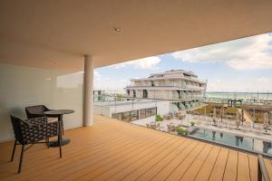 a room with a balcony with a view of the ocean at BIRGÉS HOTEL Lifestyle and View in Balatonfüred