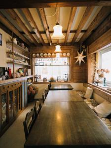 a large wooden table in a room with chairs at Polar Bear 藏王白熊民宿 in Kaminoyama