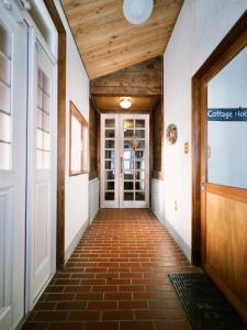 a hallway of a building with wooden ceilings and a door at Polar Bear 藏王白熊民宿 in Kaminoyama +29 photos