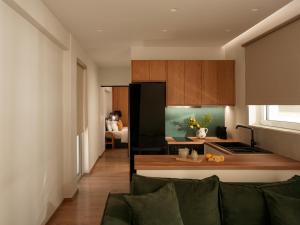 a kitchen with a black refrigerator and a table at Eudaimonia - Luxury Apartment in Agrinio in Agrinio