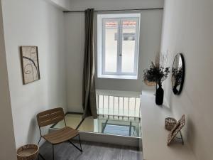 a living room with a chair and a window at Splendide duplex en plein coeur de Vernon in Vernon