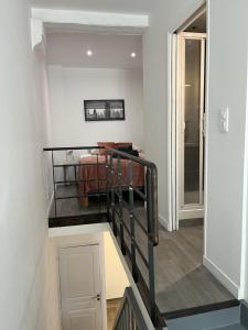 a stairway leading to a room with a bed at Splendide duplex en plein coeur de Vernon in Vernon