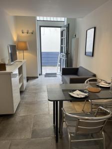 a kitchen and a living room with a table and chairs at Splendide duplex en plein coeur de Vernon in Vernon