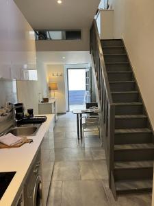 a kitchen with a staircase leading to a dining room at Splendide duplex en plein coeur de Vernon in Vernon