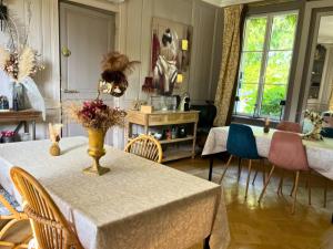 a dining room with a table with chairs and a tableablish at Maison Menadel in Yvetot