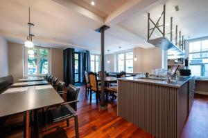 a kitchen and dining room with tables and chairs at Hotel Ochsen - Self Check-in in Uster