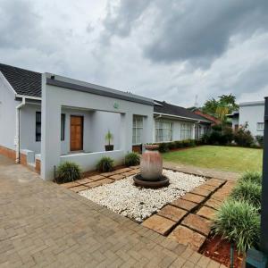 a house with a fountain in the front yard at L'Mida in Klerksdorp