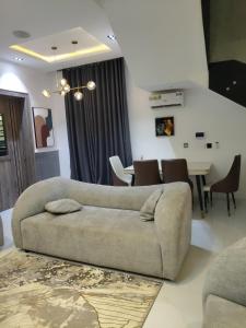 a living room with a couch and a table at 5 bedroom apartment Magodo GRA in Sagisa
