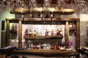 a shelf with bottles of alcohol on a wall at Lala Resort in Kolgecaj