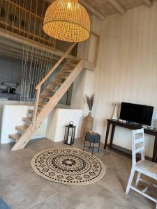 a living room with a staircase and a rug at Casa Luca in Drios