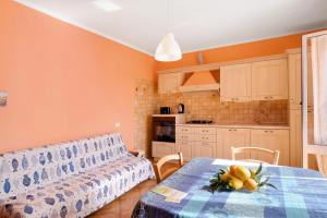 a kitchen with a couch and a table in a room at Paola in Villa Faraldi +12 photos