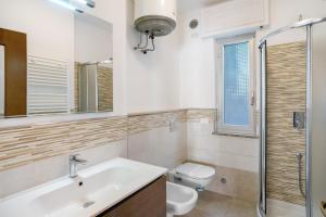 a bathroom with a sink and a toilet and a mirror at Paola in Villa Faraldi