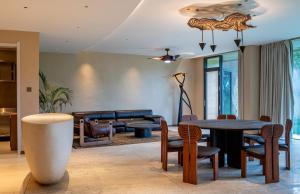 a living room with a table and chairs and a couch at Pristine Mara Bay Lodge in Masai Mara