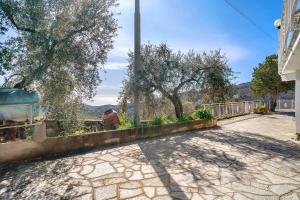 a man sitting on a wall next to a street at Paola in Villa Faraldi