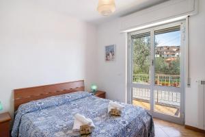 a bedroom with a bed and a large window at Paola in Villa Faraldi