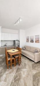 a living room with a table and a couch at Vila Tirona in Durrës
