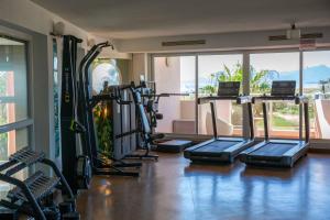 a gym with a bunch of treadmills in a room at Grand Hôtel Les Flamants Roses Thalasso & Spa in Canet-en-Roussillon