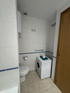 a small bathroom with a toilet and a sink at Espalmador E10, RT259PL in Es Pujols