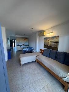 a living room with two beds and a couch at Espalmador E10, RT259PL in Es Pujols